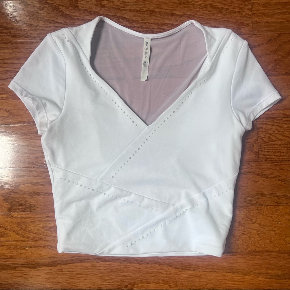 Athleta Women’s white size XXS, athletic top with detailing and sheer back